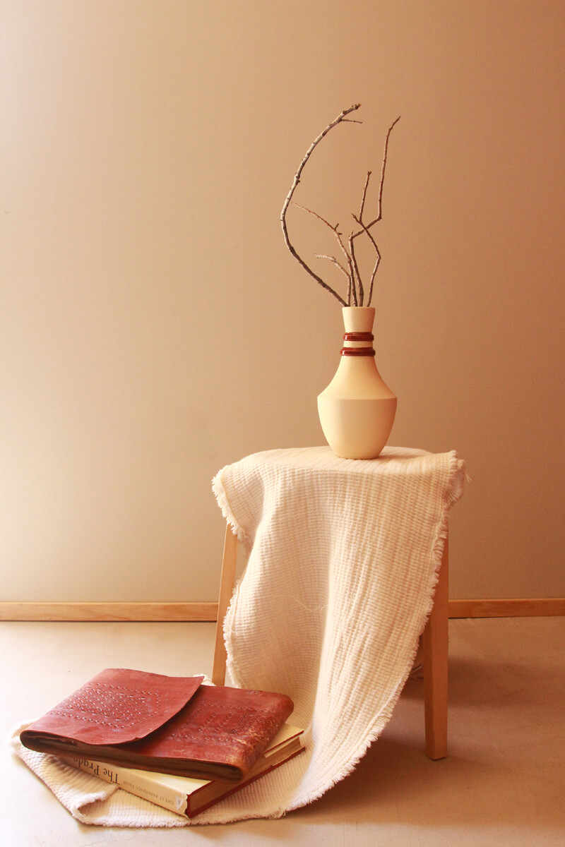 Alignment sculptural vase on dining table, minimalist home décor vignette