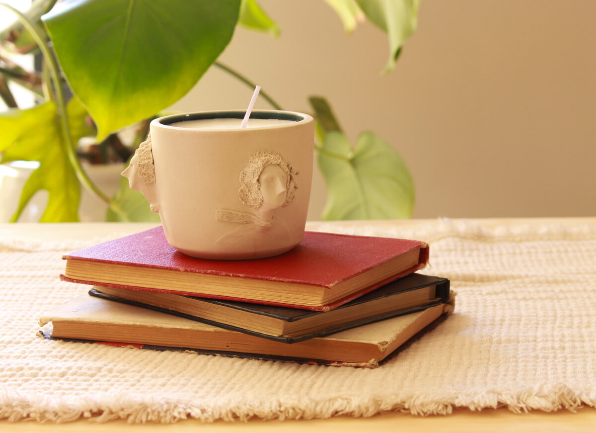 close-up of sculpted faces on The Wonderstruck ceramic holder, side detail