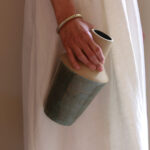 Hand holding Reflection handmade ceramic vase with sculptural industrial form