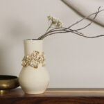 Afternoon Delight ceramic vase with floral band and gold accents styled on shelf