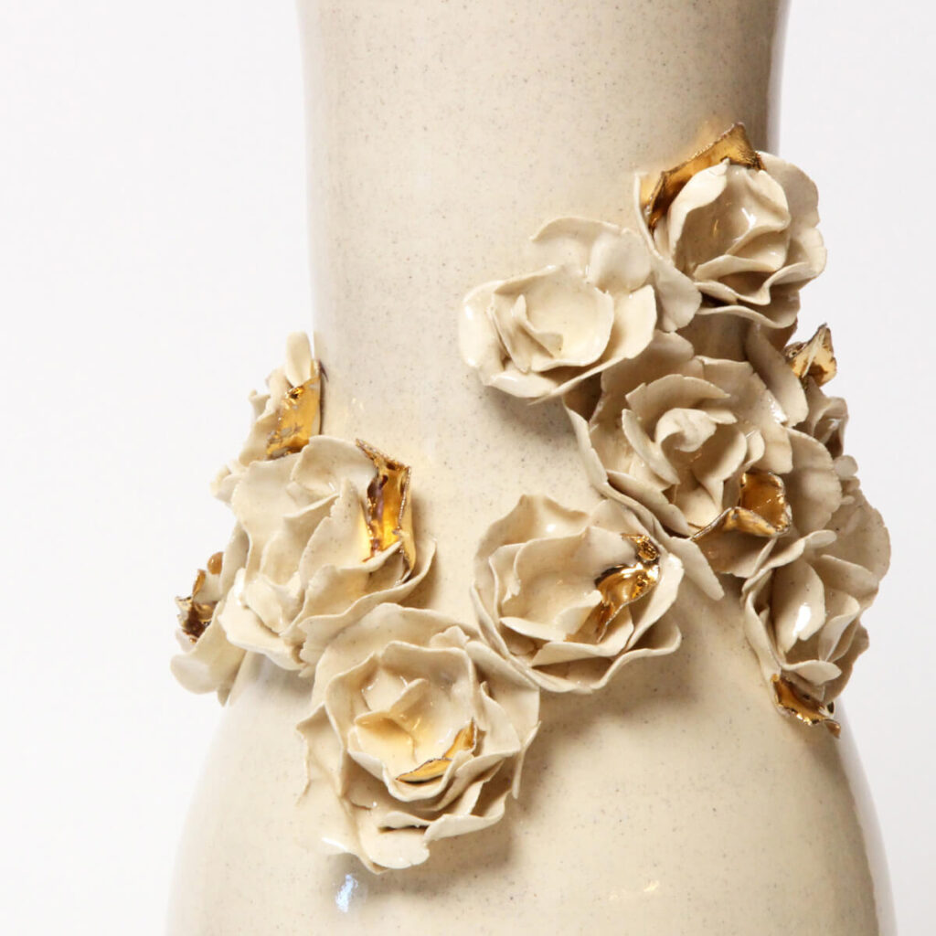 Eden Rose under Golden Dawn floral ceramic vase with sculpted roses and gold accents
