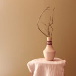 Alignment handmade ceramic vase styled with branches on stool