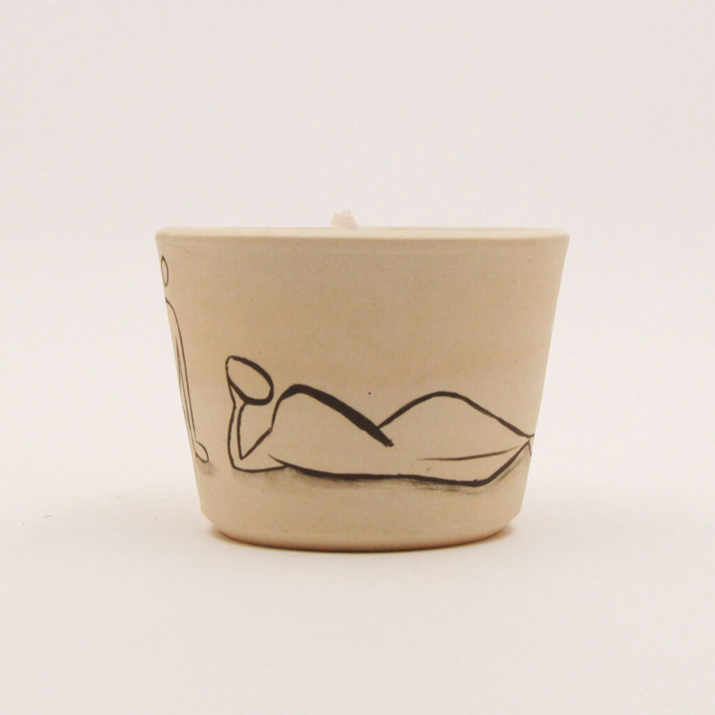 Ceramic candle holder with reclining abstract figure illustration