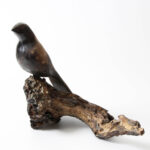 Nomad ceramic bird sculpture main view with bird perched on weathered branch