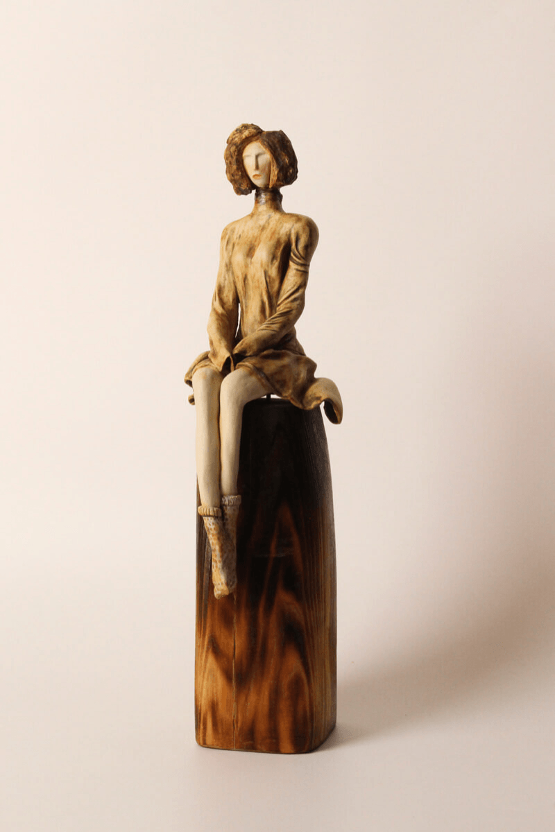 Poised handmade ceramic figurative sculpture front view on tall pedestal - home thumbnail