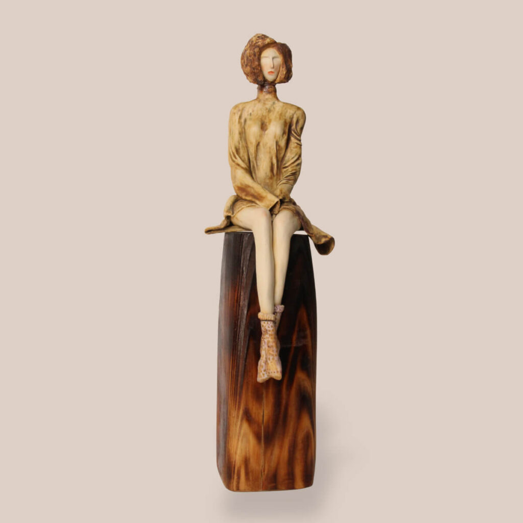 Poised ceramic sculpture main image with seated female figure on pedestal