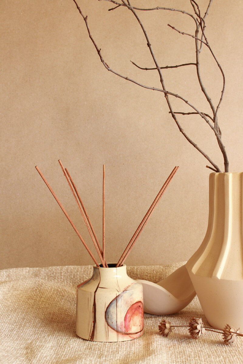 Skyflower reed diffuser shown from another angle with painted underglaze detail