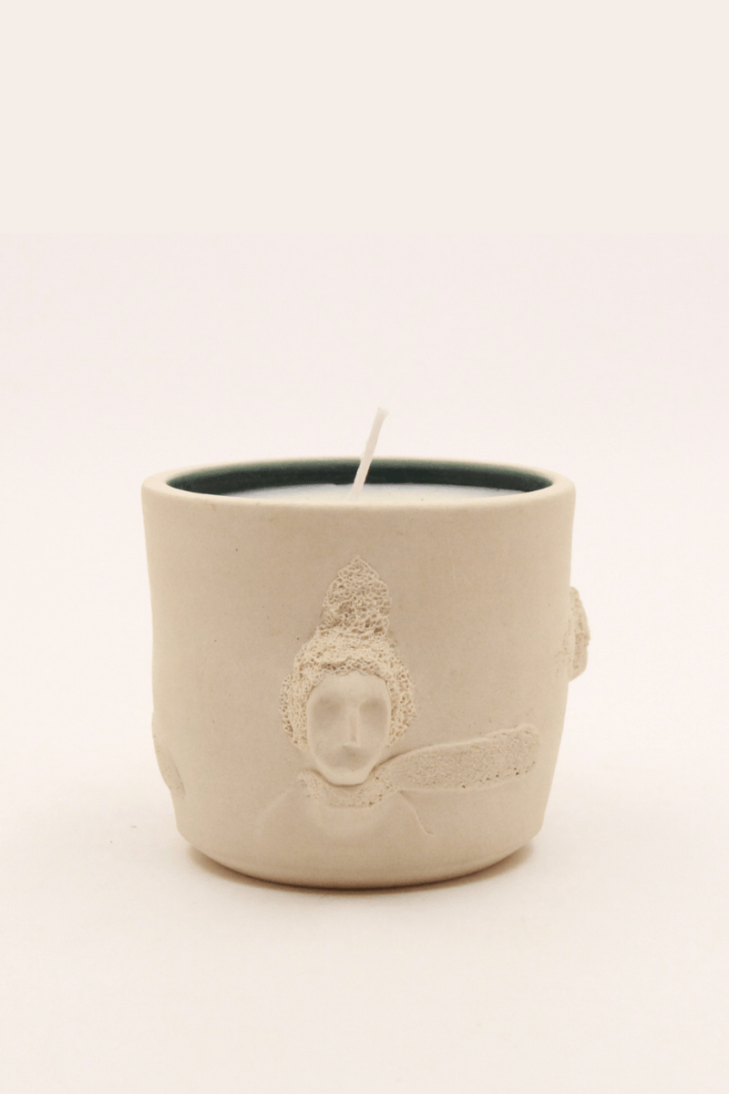 Decorative candle with artistic design.