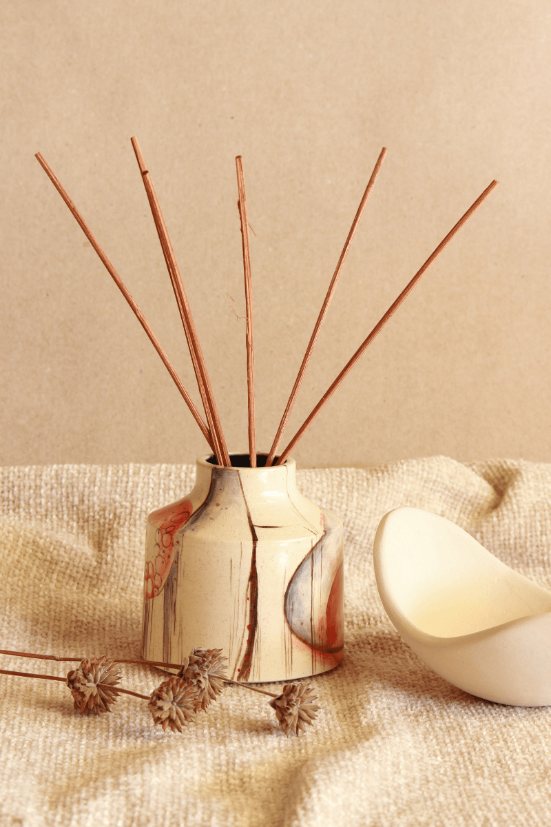 Decorative diffuser with natural reeds.